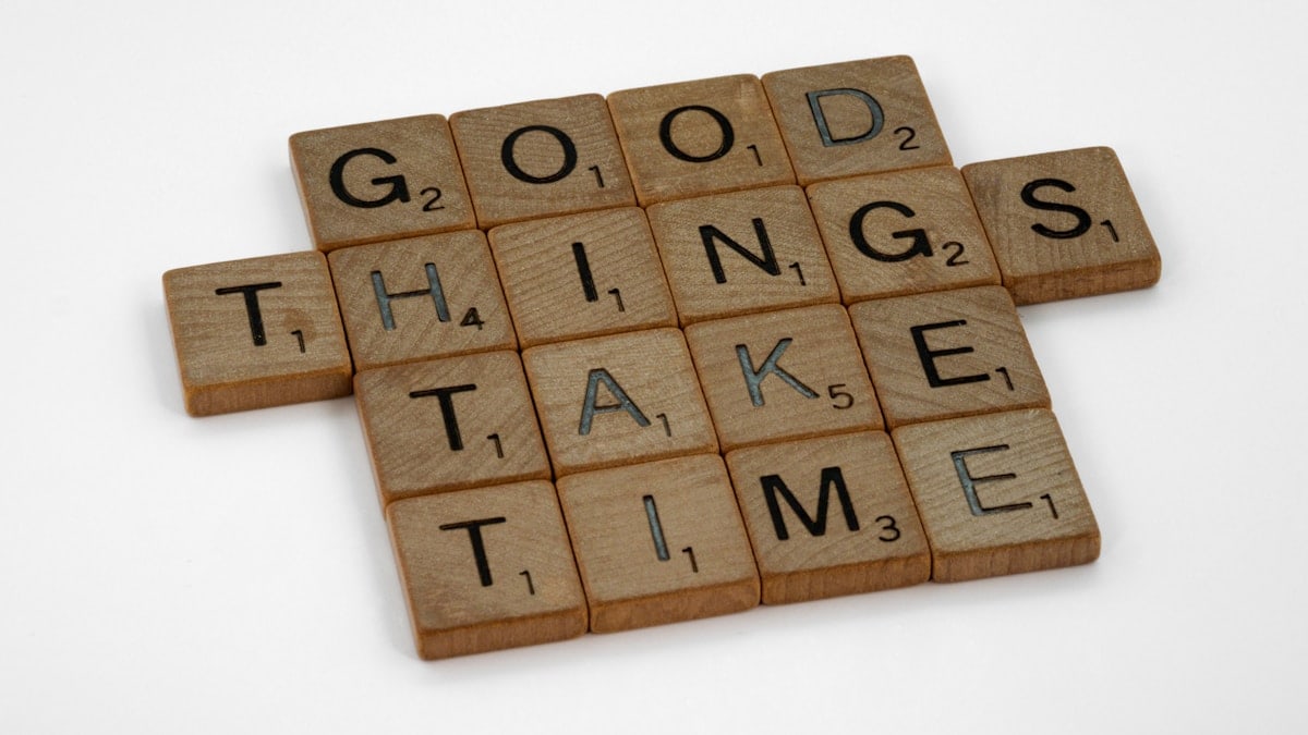 scrabble, scrabble pieces, lettering, letters, wood, scrabble tiles, white background, words, quote, letters, type, typography, design, layout, focus, bokeh, blur, photography, images, image, good things take time, patience, hard work, progress, incremental change, going for the long haul, commit, one day at a time, never give up, keep going, long haul, discipline, practice, practise, turn up,